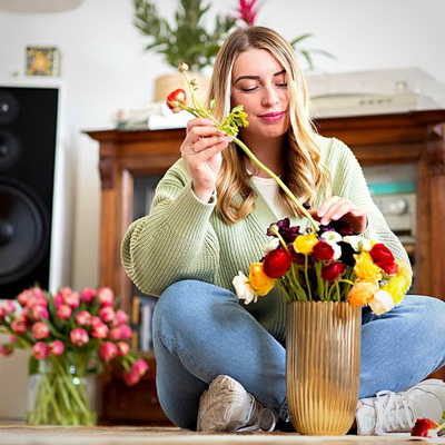 arranging flowers in a vaseThursd